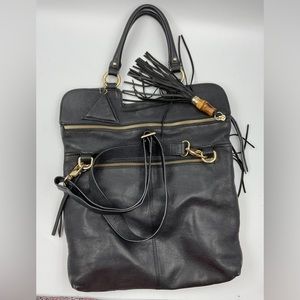 Beautiful leather purse with gold hardware and a tassel with a bamboo accent.